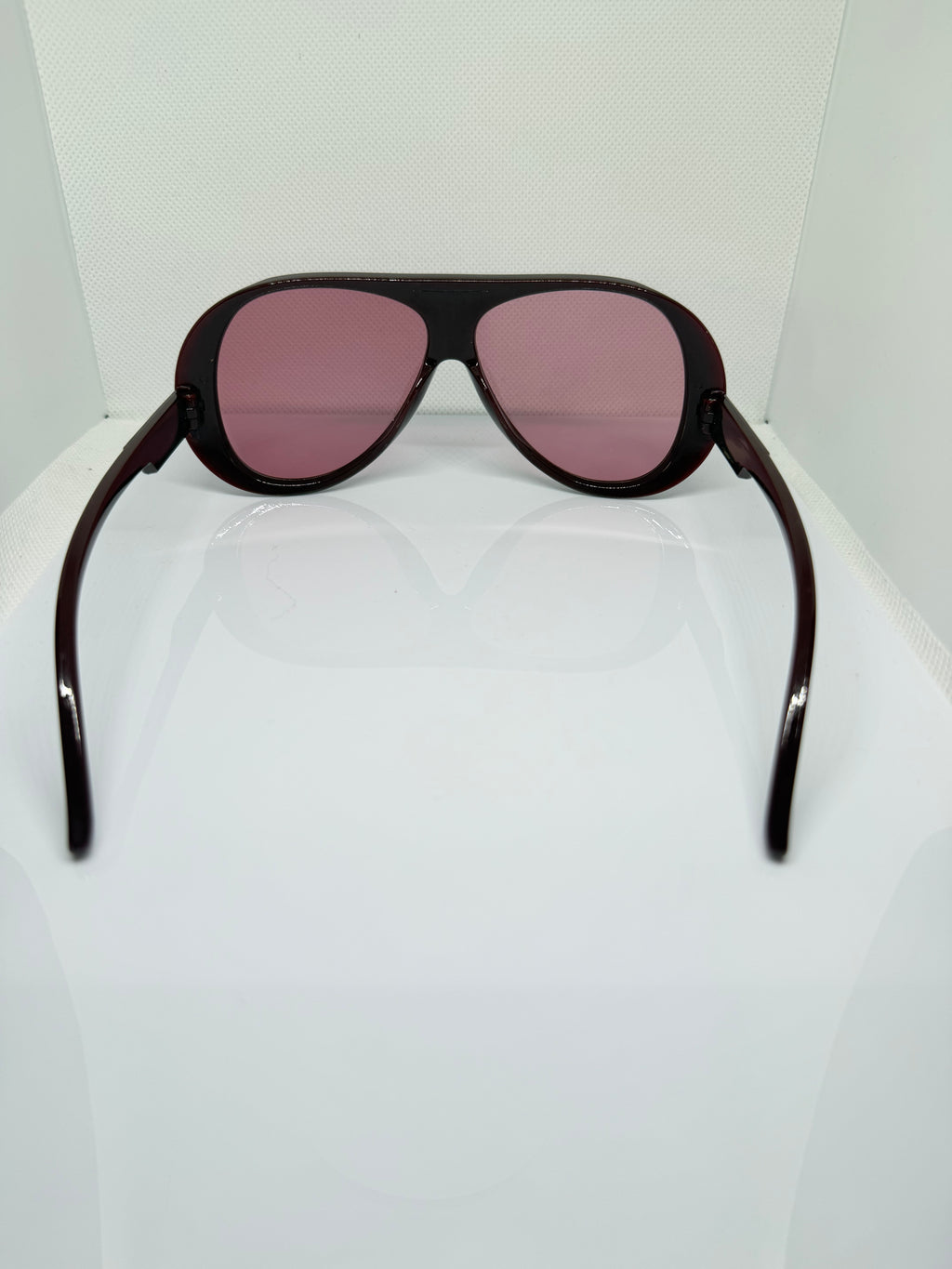 Close-up of Merlot sunglasses showing the pink-purple tinted lenses