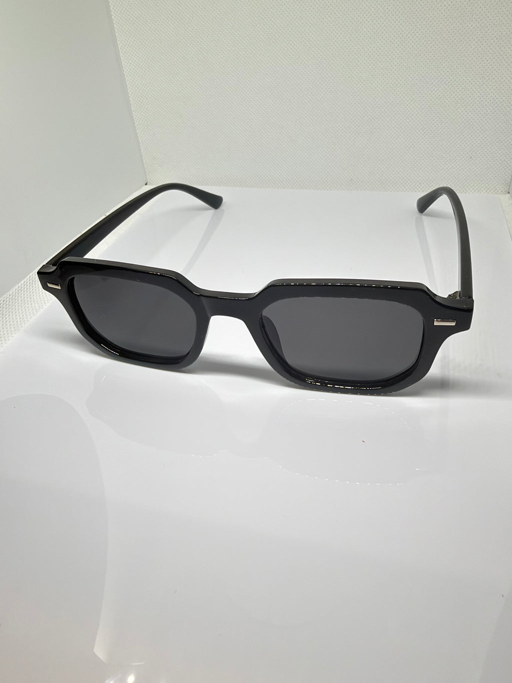 Oslo sunglasses featuring a sleek black frame and classic rectangular shape