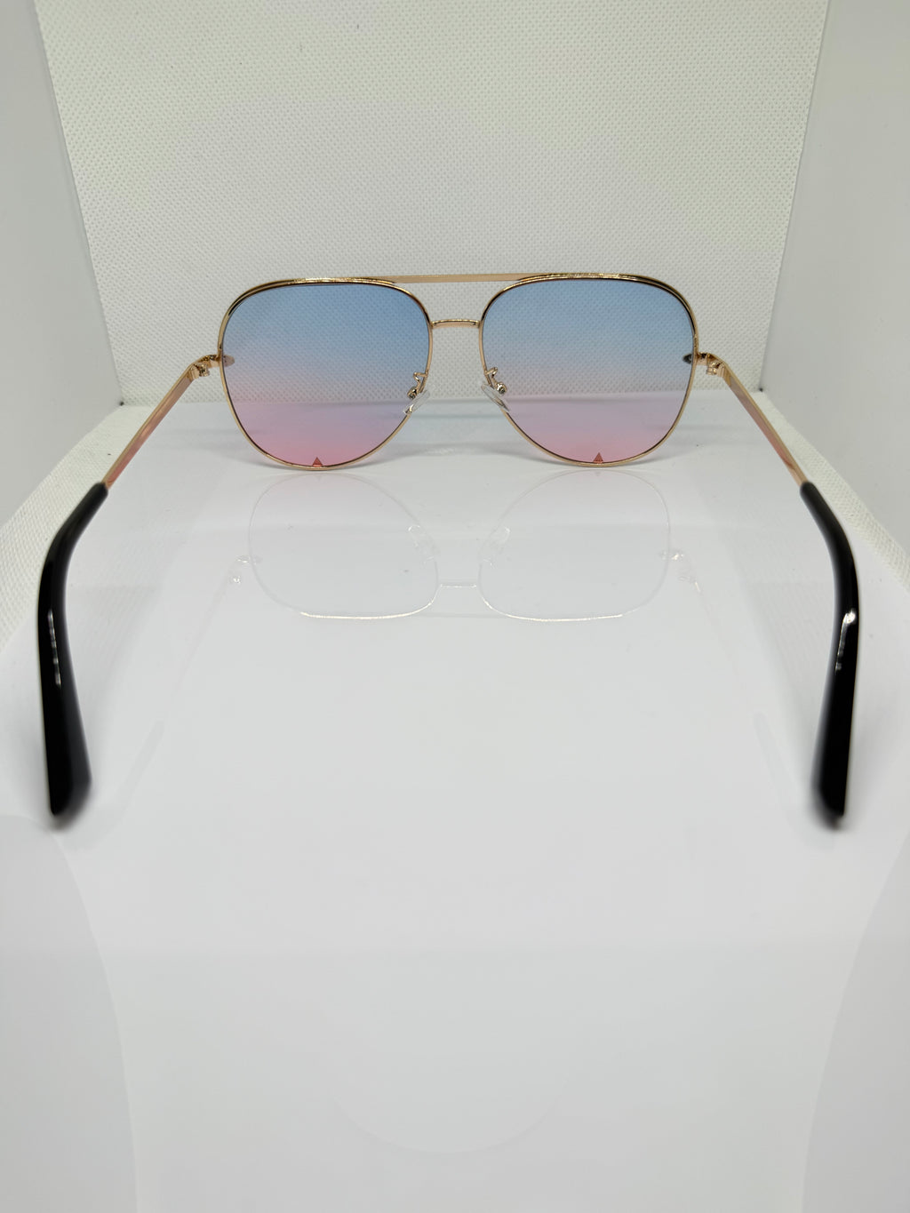 Close-up of Ibiza sunglasses showing the gold-tone frame