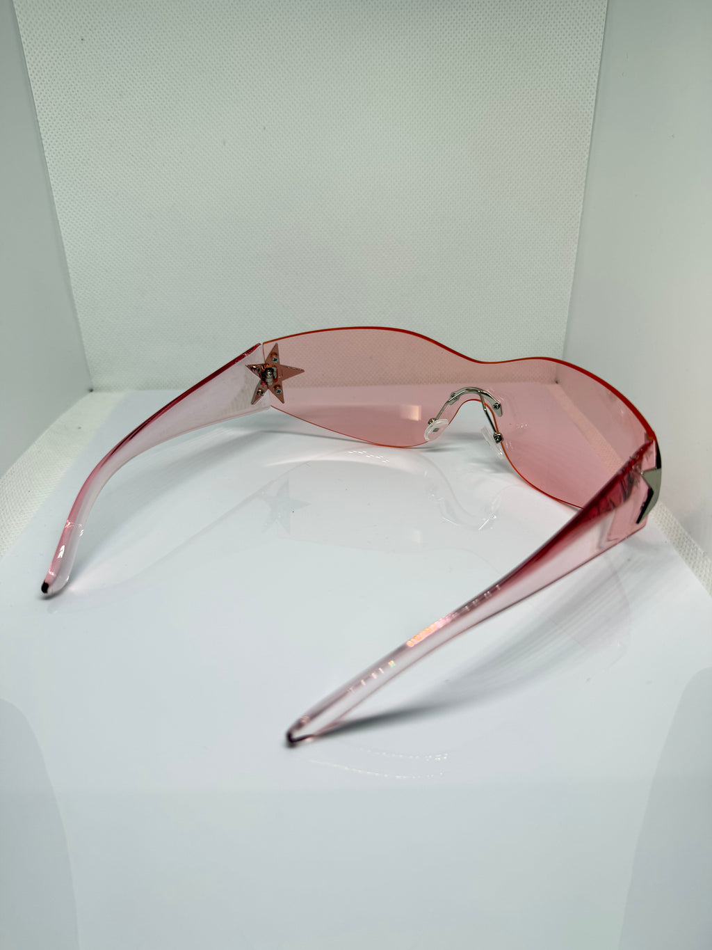 Stella blush pink shield sunglasses with a sleek oversized shape