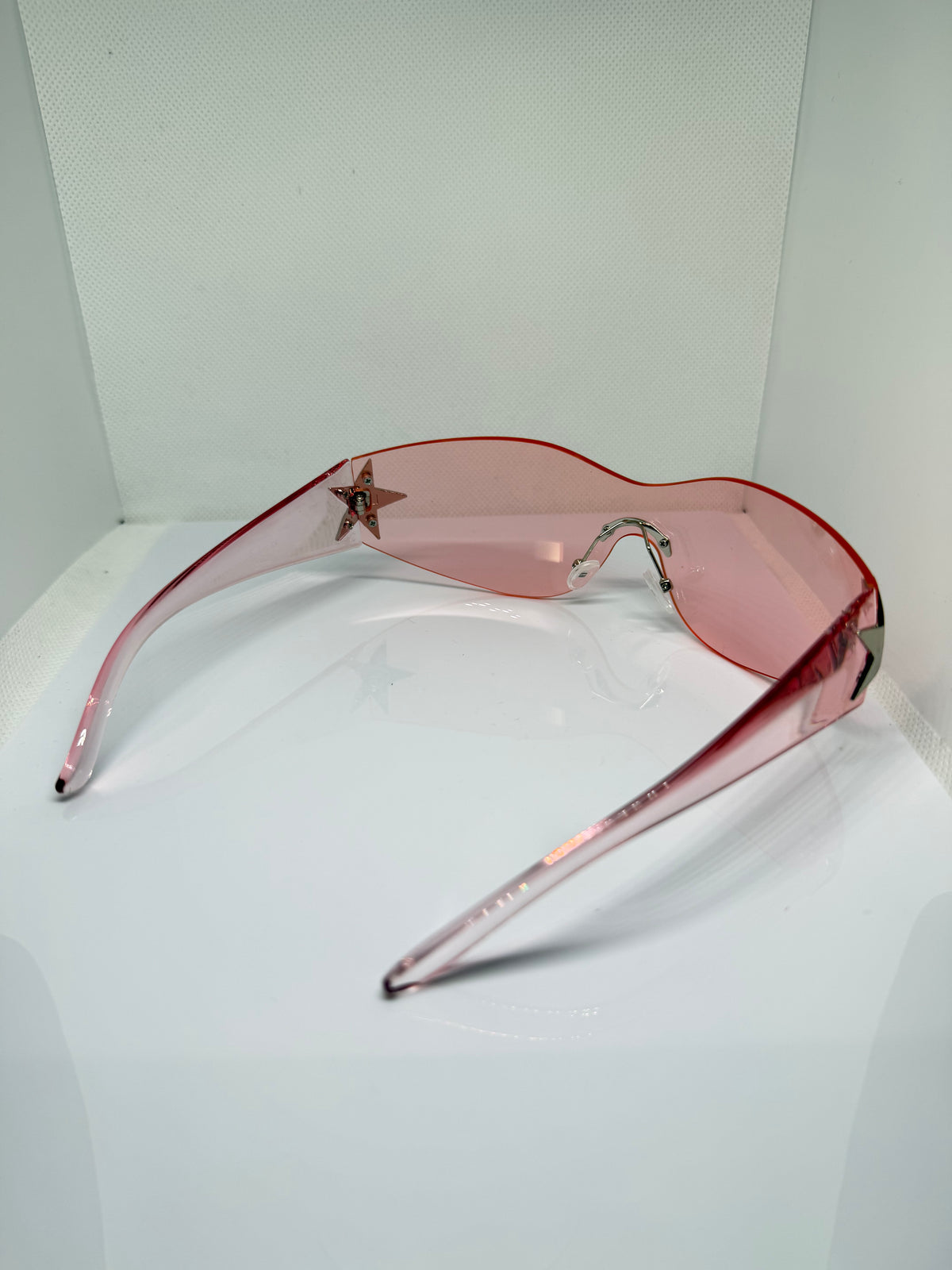 Stella blush pink shield sunglasses with a sleek oversized shape