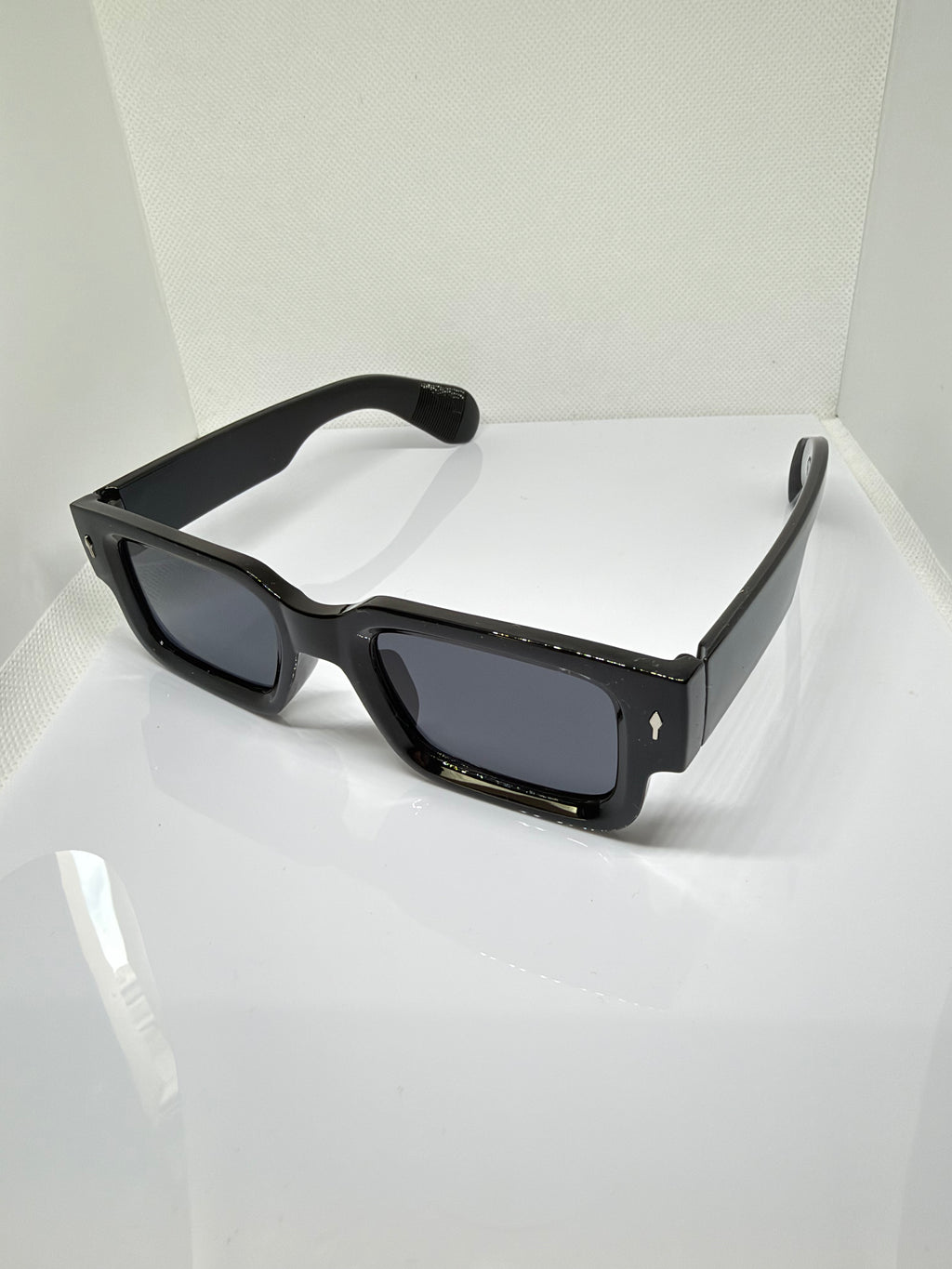 Obsidian sunglasses featuring a bold rectangular frame and thick black temples