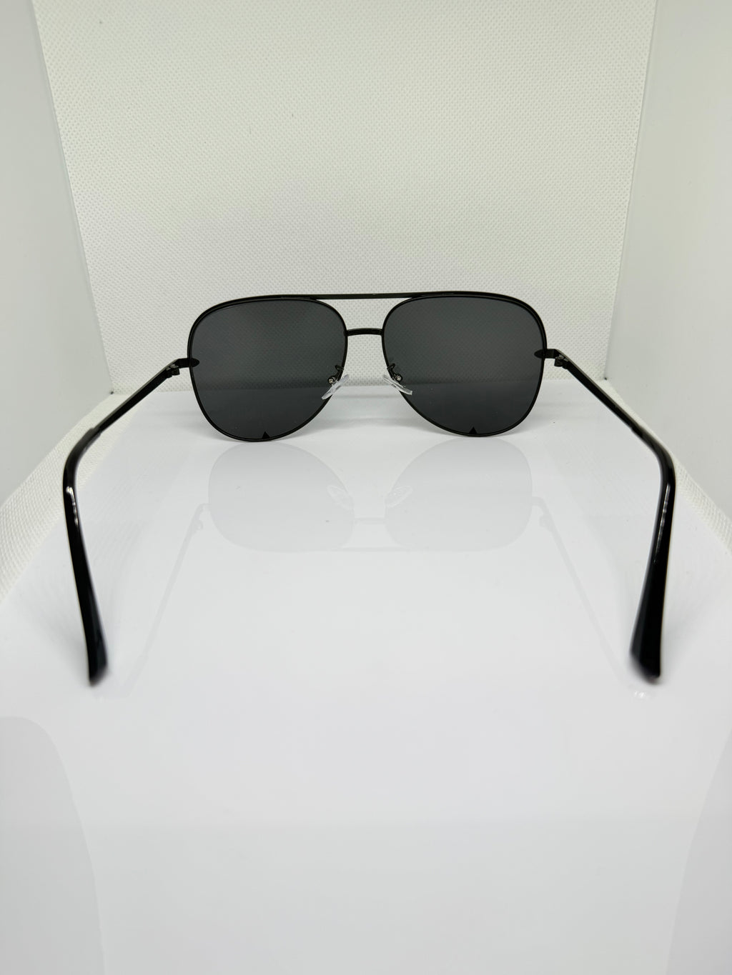 Close-up of Shadow black aviator sunglasses showing the dark lenses