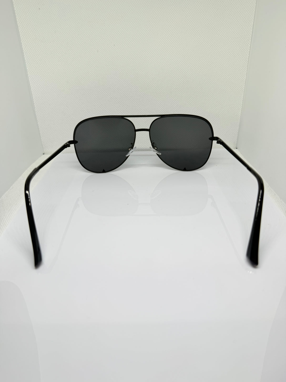 Close-up of Shadow black aviator sunglasses showing the dark lenses