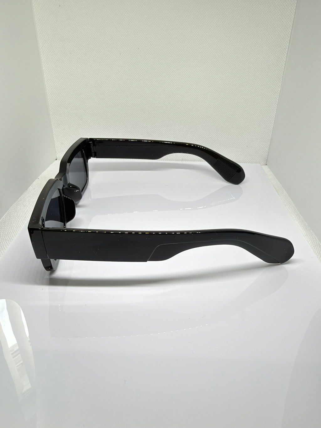 Close-up of Obsidian chunky black sunglasses showing the glossy frame