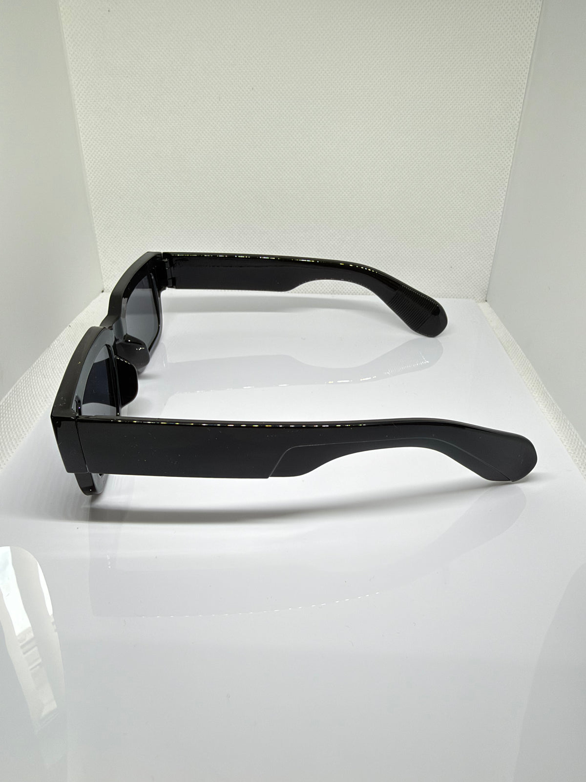 Close-up of Obsidian chunky black sunglasses showing the glossy frame