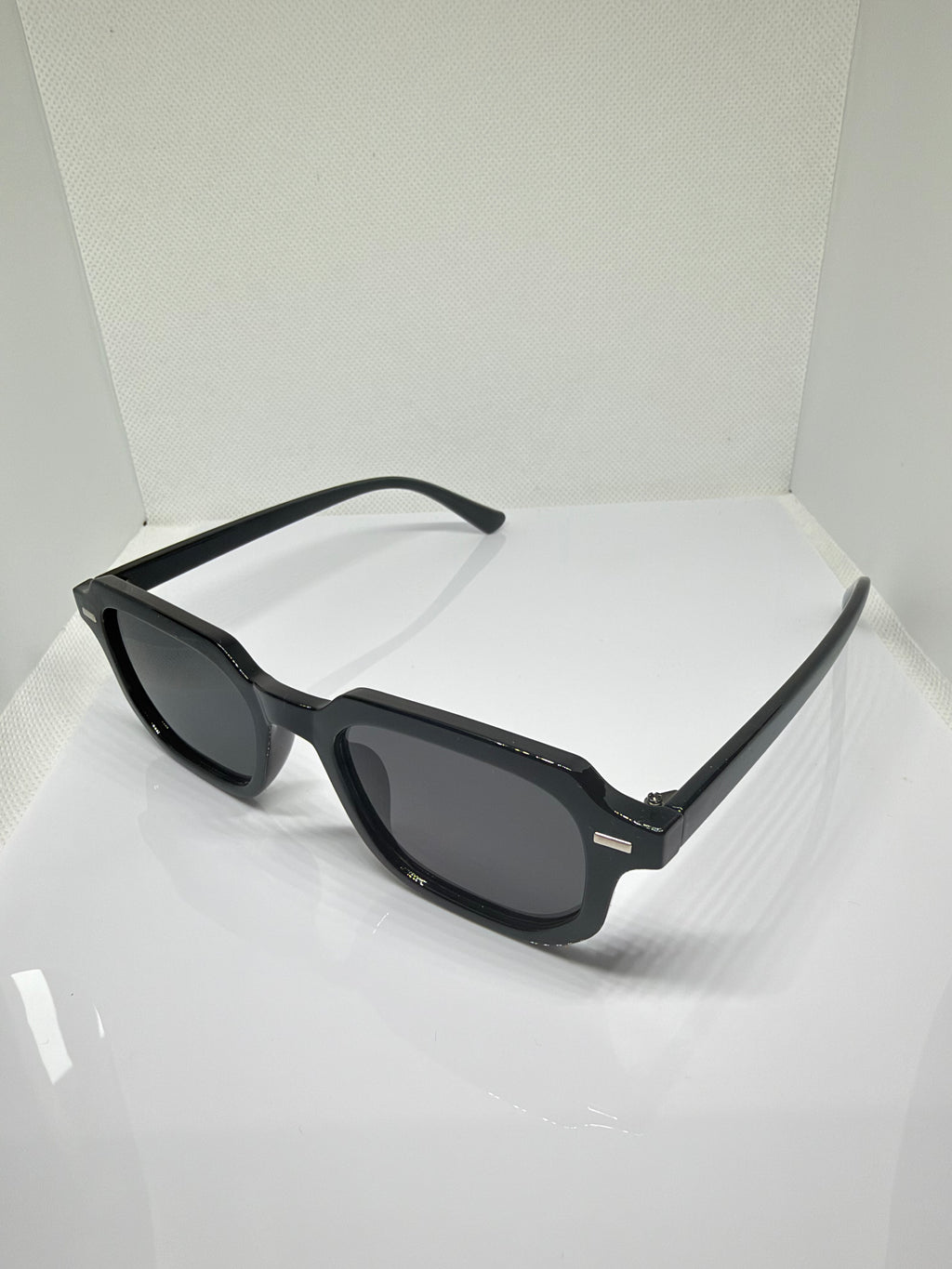 Close-up of Oslo black rectangle sunglasses showing the dark lenses