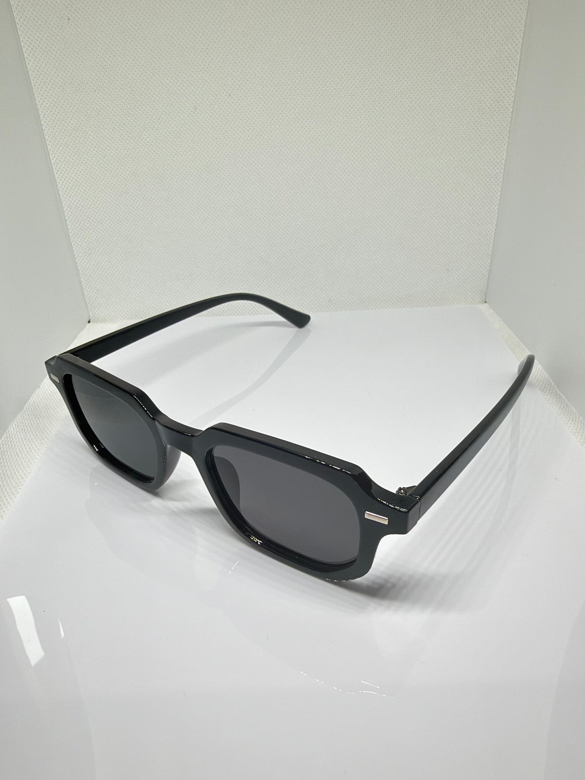 Close-up of Oslo black rectangle sunglasses showing the dark lenses