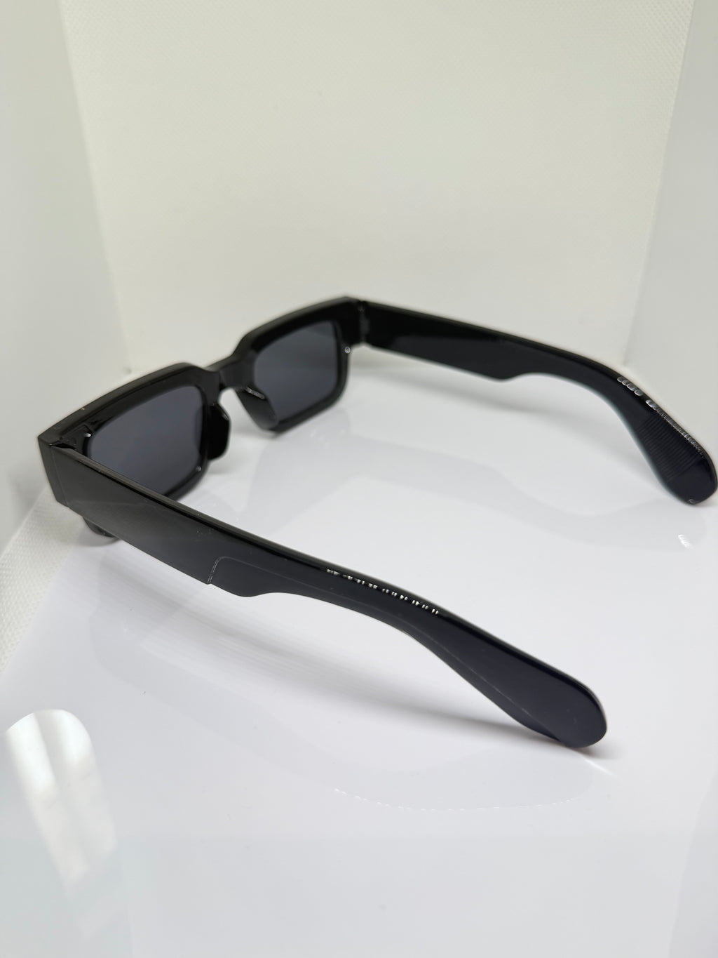 Obsidian chunky rectangle sunglasses with dark lenses and substantial temples