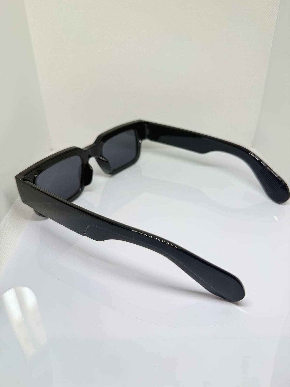 Obsidian chunky rectangle sunglasses with dark lenses and substantial temples
