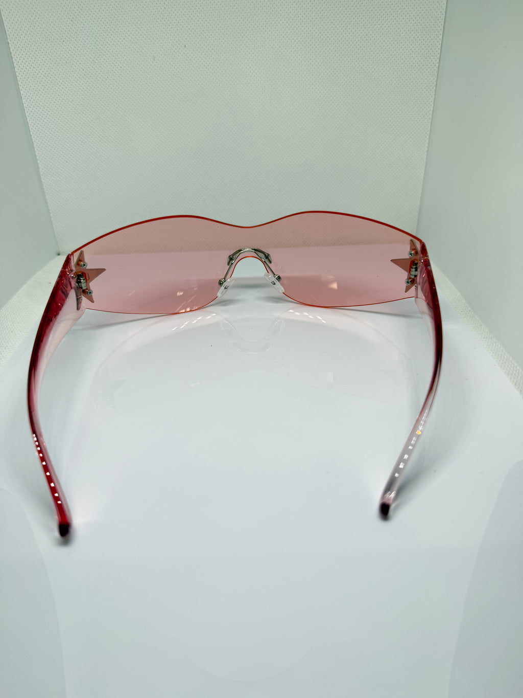 Close-up of Stella sunglasses showing the pink shield design
