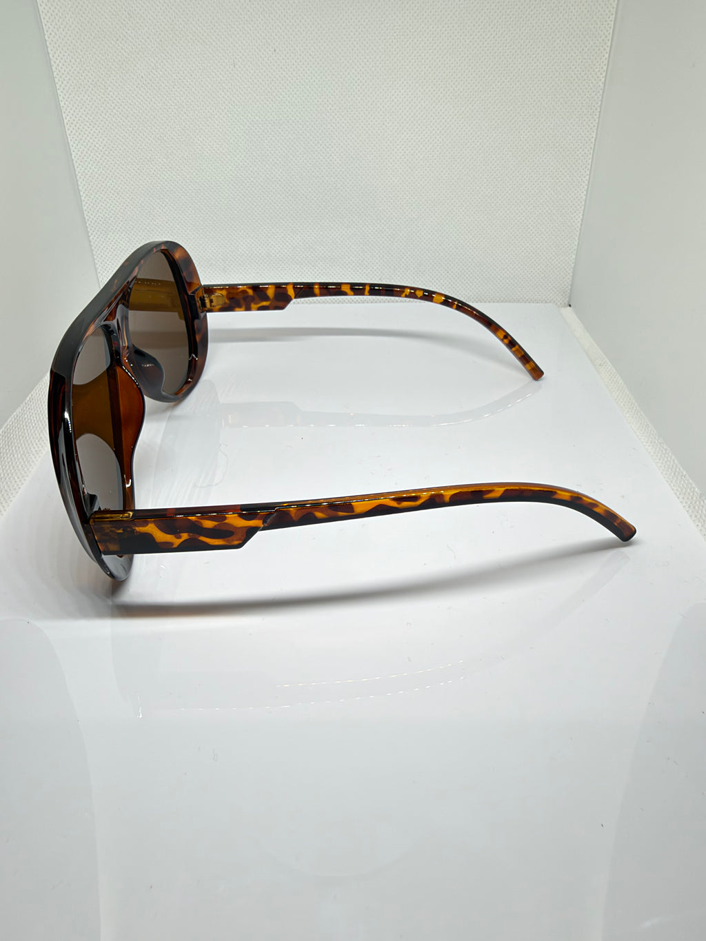 Close-up of Havana sunglasses showing the brown tortoiseshell frame