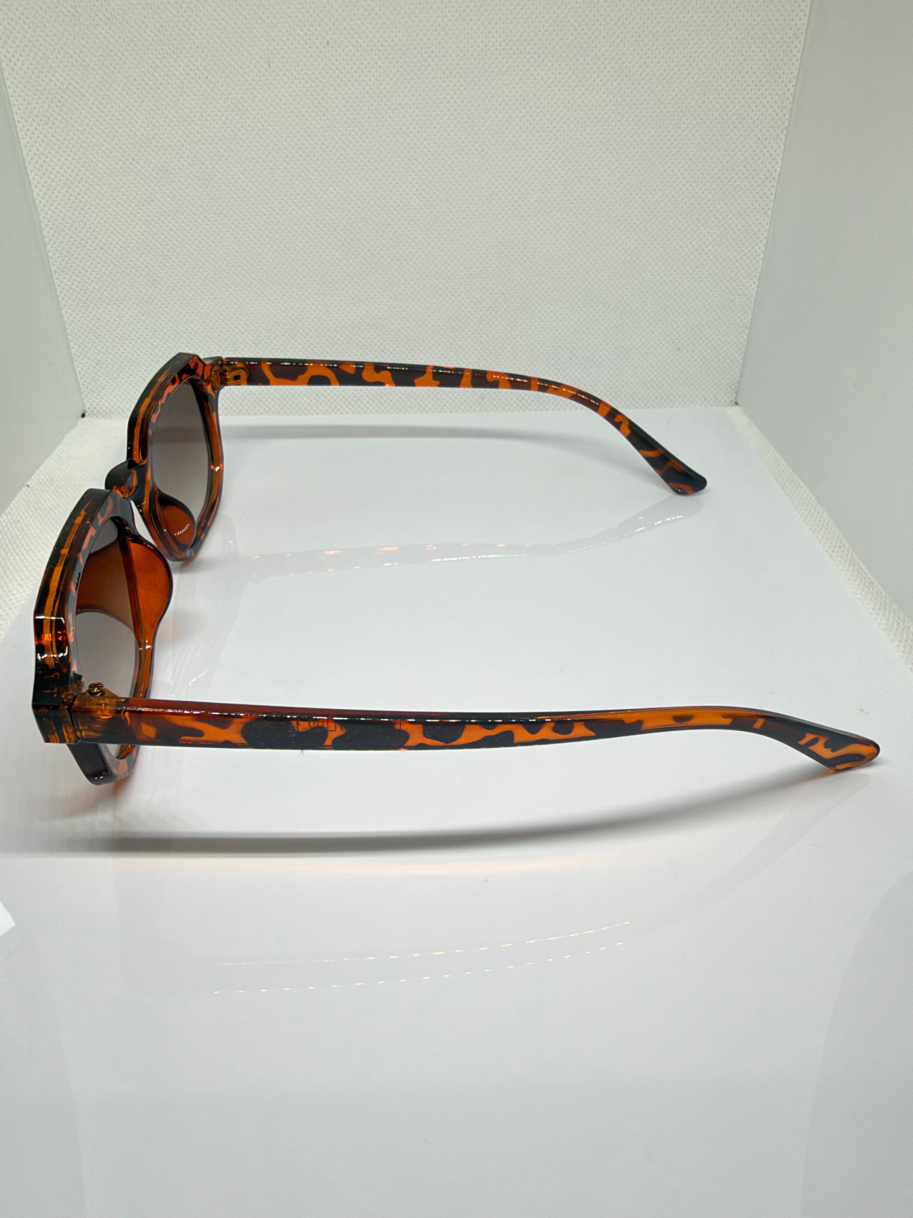 Close-up of Capri tortoiseshell sunglasses showing the brown gradient lenses